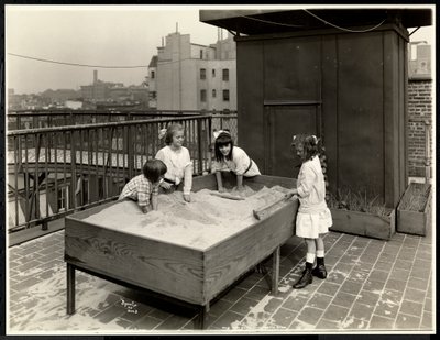 Blind girls playing in sand box on the roof of the New York Association for the Blind, 111 East 59th Street, New York, 1926 by Byron Company